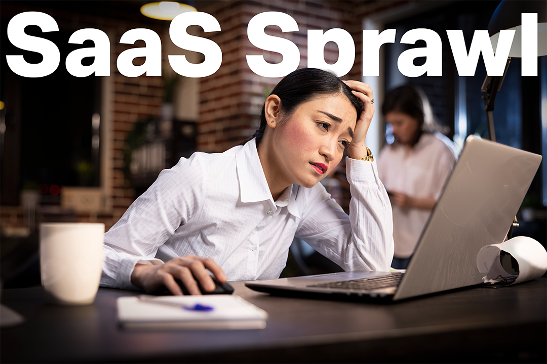 Stressed professional working late at a desk under SaaS Sprawl text